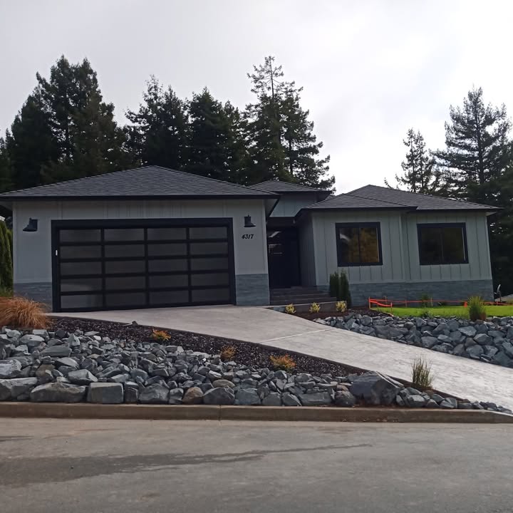 Finished custom home exterior with rock landscaping